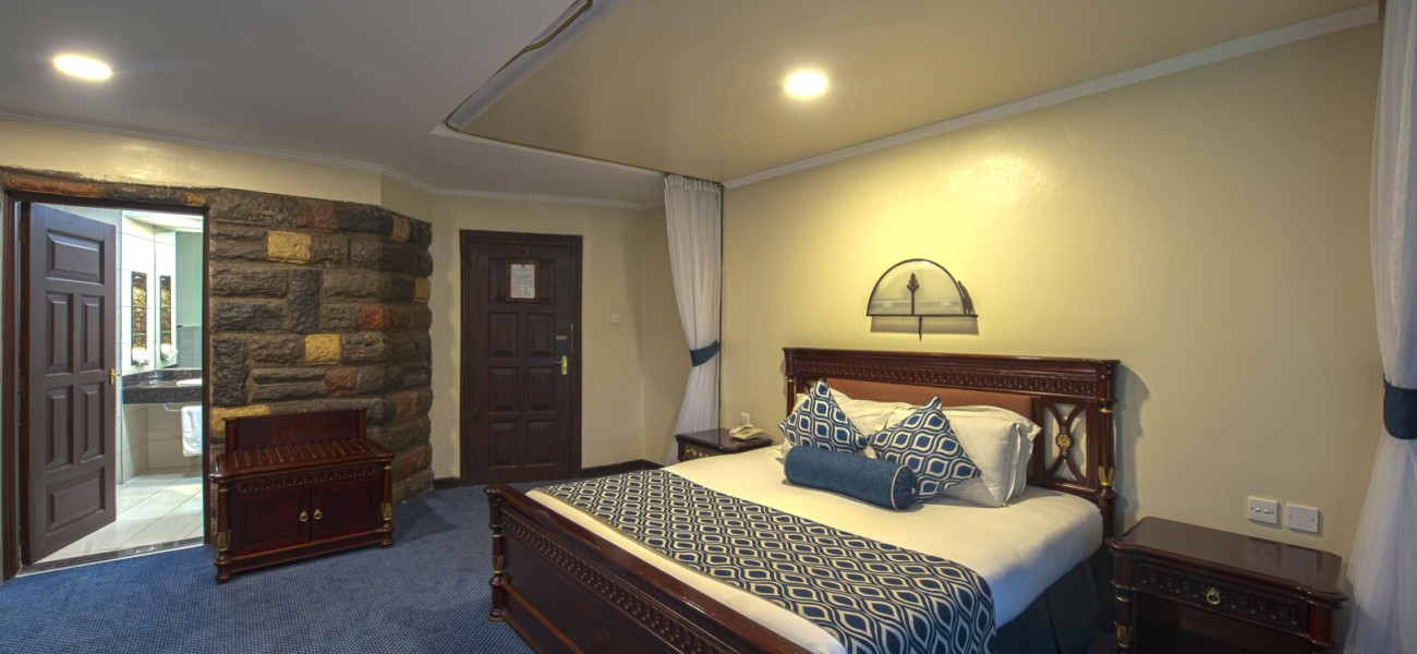 Lake Naivasha Sopa Resort surrounded by lush gardens and acacia trees in Kenya